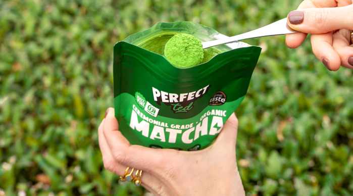 An open pouch of PerfectTed Matcha with a full spoon of Matcha Powder being taken out